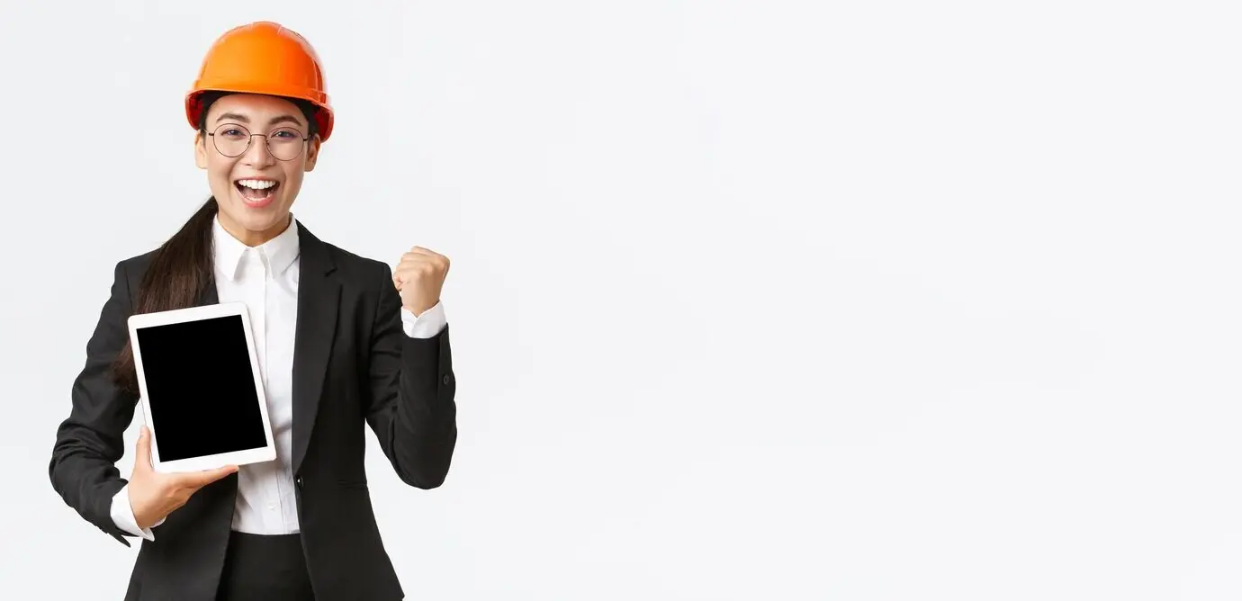 Erfolgreiche Ingenieurin und Bauleiterin in einer Fabrik, mit Sicherheitshelm und Businessanzug.